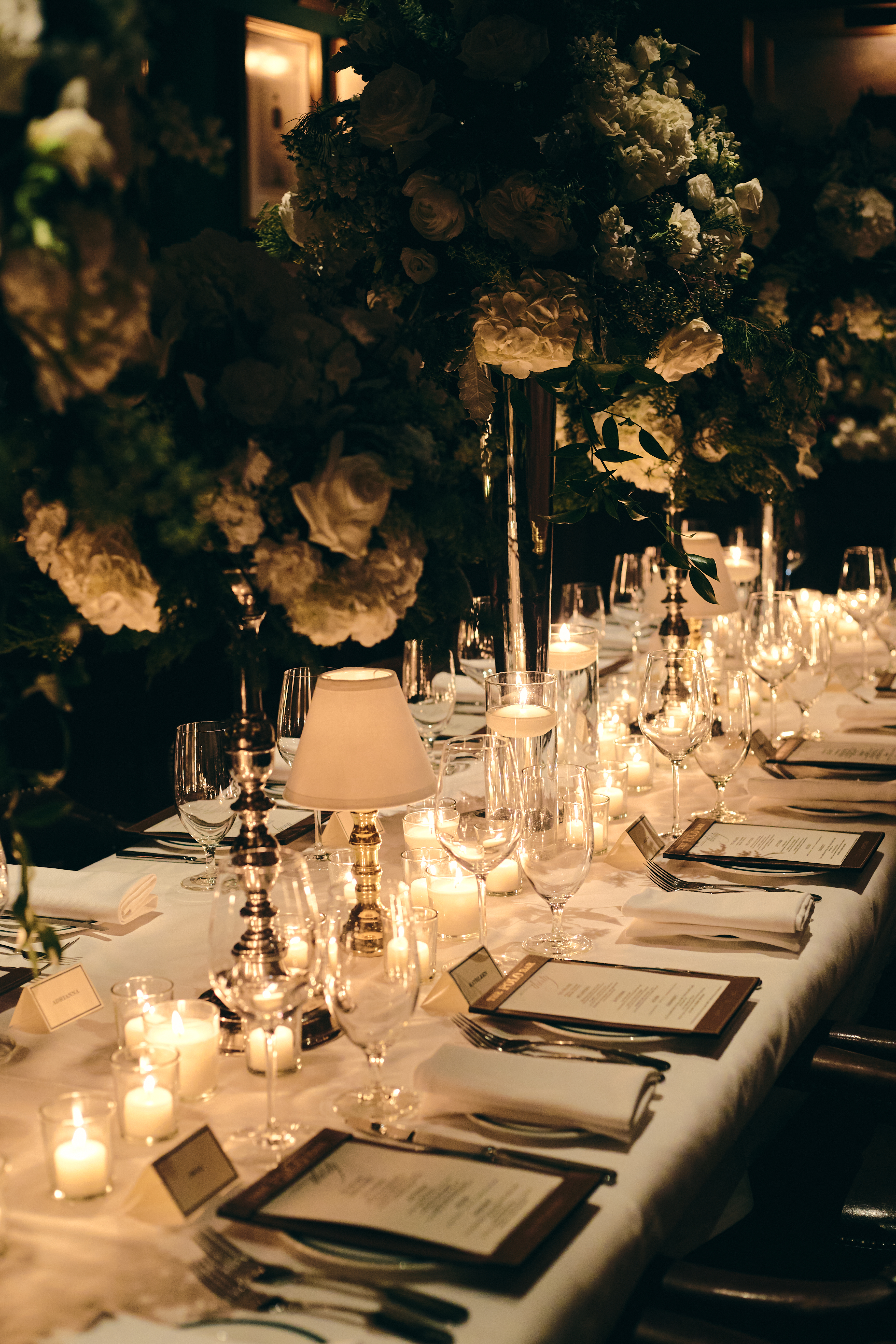 A formal dining table with candles and florals.